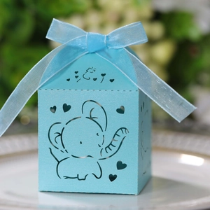 Detail of light blue laser-cut candy box with elephant pattern and ribbon bow