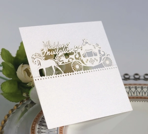 Detail view of laser-cut royal carriage wedding invitation card with pearl finish