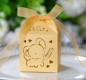 Detailed laser-cut champagne gold favor box with hollow elephant and heart patterns