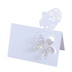 Macro view of laser-cut wedding place card with 3D floral accent and female silhouette