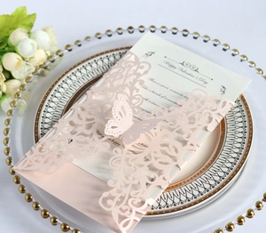 Detail of laser-cut pink wedding invitation with a 3D butterfly and romantic text