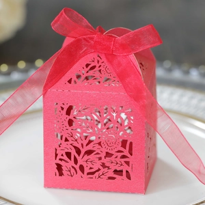 Macro detail of laser-cut rose gift box in magenta paper with elegant organza ribbon