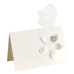 Detailed laser-cut pearl white wedding place card featuring 3D paper flower and silhouette