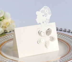 Close-up of elegant laser-cut place card with 3D paper flower on white pearl cardstock