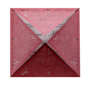 Detail of laser-cut hollow mandala patterns on a luxury wedding invitation card
