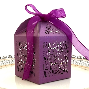 Detailed laser-cut pattern on purple paper gift box with elegant organza ribbon bow