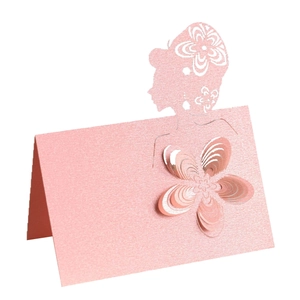 Detail of pink pearlescent place card with laser-cut female silhouette and 3D paper flower