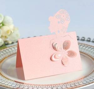 Detailed laser-cut wedding place card with 3D flower and pearlescent pink finish