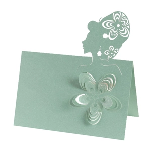 Macro detail of laser-cut 3D floral place card with an elegant female silhouette