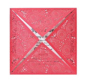 Detail of red laser-cut geometric floral invitation sleeve with a white paper insert