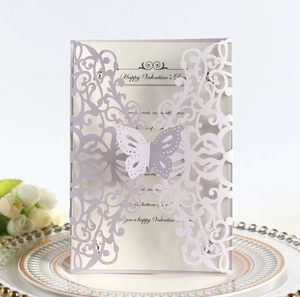 Macro view of laser-cut butterfly clasp on lavender card with embossed plate