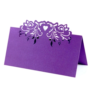 Detailed laser-cut heart and floral pattern on a dark purple pearl cardstock table card