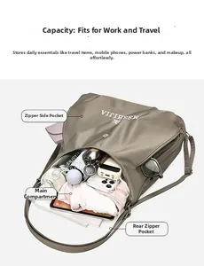 Detail showing high-capacity khaki tote bag filled with essentials like phone and umbrella