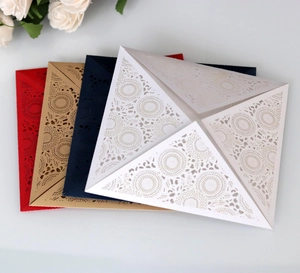 Macro detail of laser-cut mandala floral patterns on elegant multicolored wedding invitations