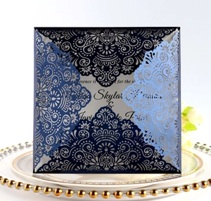 Navy blue laser cut wedding invitation card with intricate mandala floral hollow design