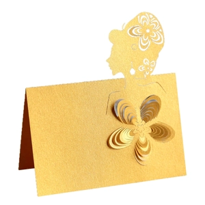 Detail of laser cut gold place card with 3D paper flower and female silhouette