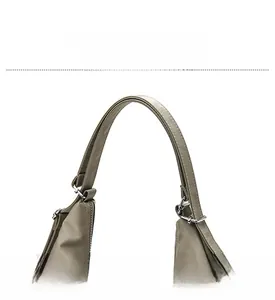 Detail of durable earth-tone shoulder strap with silver metal buckle and reinforced stitching