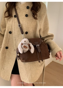 Sophisticated retro dark brown matte leather bag with cute plush bunny charm detail
