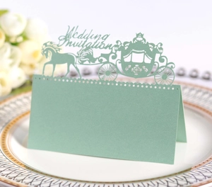 Laser-cut wedding place card with a royal carriage design in mint green paper