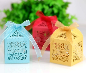 Detailed laser-cut rose floral patterns on elegant gift boxes with satin ribbons