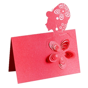 Detail of red laser-cut place card featuring a 3D paper flower and silhouette design