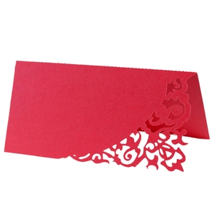 Elegant laser-cut red wedding place card with intricate floral patterns and glitter finish