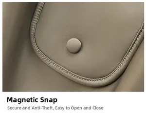 Detail of the high-quality magnetic snap closure on a beige leather tote bag