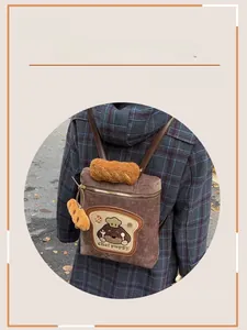Detail of brown corduroy backpack with Chef puppy toast embroidery and plush charm