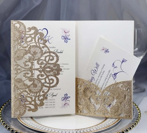Detailed laser-cut gold glitter wedding invitation with elegant white printed insert card