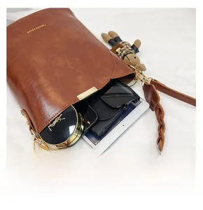 Spacious interior of vintage brown leather bucket bag showing storage for daily essentials