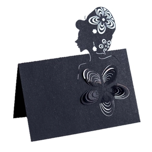 Macro detail of laser-cut floral pattern and elegant silhouette on black wedding place card