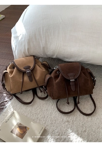 Retro style camel and dark brown suede mini backpacks with leather trim on white rug