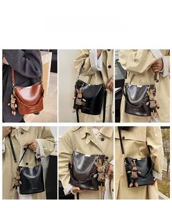 Detailed views of vintage bucket bags in brown and black with cute bunny charm accessory