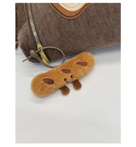 Plush cartoon bread charm detail with fluffy texture hanging on a brown corduroy bag