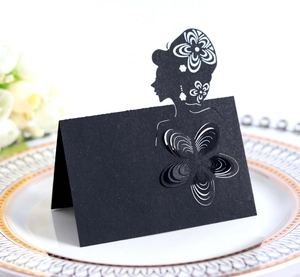 Detail of laser-cut black place card featuring 3D paper flower and female silhouette