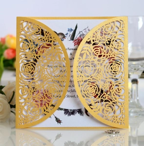 Detailed laser-cut rose patterns on elegant gold pearlescent wedding invitation card
