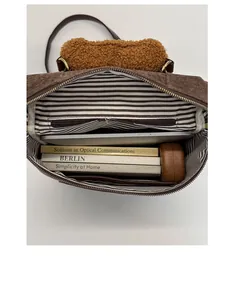 Spacious dark brown corduroy bag interior with striped lining and teddy plush handle