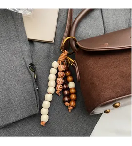 Detailed close-up of retro wooden beaded bag charm with leopard and ethnic patterns