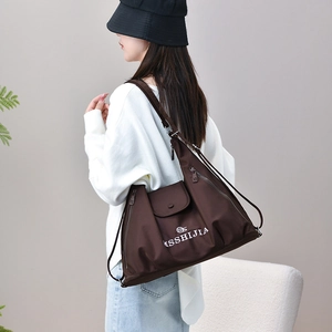 Detail view of coffee nylon backpack with brand logo on a soft minimalist background