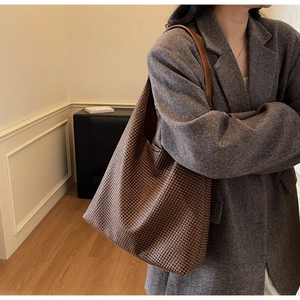 Close-up of the large woven hobo bag texture and comfortable wide shoulder strap design