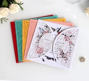 Detailed laser-cut rose patterns on wedding invitation covers in multiple colors