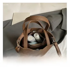 Top view of brown lychee leather bucket bag showing inner zipper pouch and large capacity