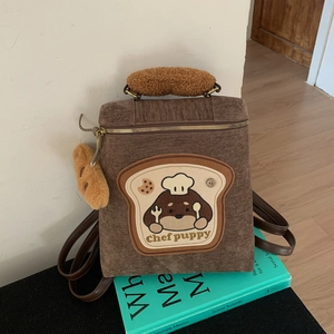 Detailed embroidery of chef puppy on brown corduroy backpack with plush charm