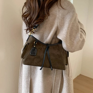Detailed side view of vintage olive green suede crossbody bag with gold hardware buckle