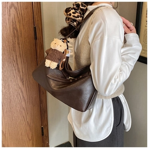 Détails de sac cabas en cuir marron avec breloques d'ours et accessoires léopard