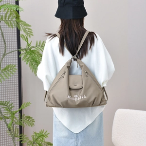 Khaki multi-functional backpack showing adjustable shoulder straps on a lifestyle model