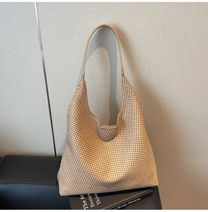 Close-up of woven houndstooth tote bag with minimalist beige and brown textured detail