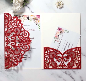 Detail of red glitter laser-cut wedding invitation set with floral inner card