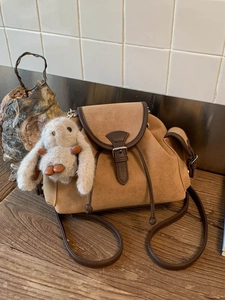 Chic brown matte crossbody bag with leather trim and a cute plush rabbit charm