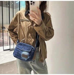 Mirror selfie showing the size and fit of this vintage blue denim mini crossbody bag